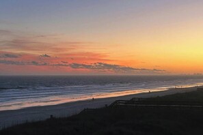 A beach with a wooden walkway and a fence. - Palmetto Dunes Unit 303 (North Myrtle Beach)