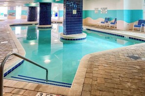 An indoor swimming pool with tiled walls and a clear pool area. - This is It 2 BR Condo (North Myrtle Beach)