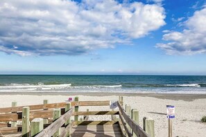 A wooden boardwalk leading to a beach with a sign indicating 'KEEP OFF DUNES'. - This is It 2 BR Condo (North Myrtle Beach)