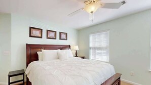 A bedroom with a bed, a nightstand, a ceiling fan, and a window with blinds. - Sterling Pointe 120-A at Wachesaw III (Murrells Inlet)