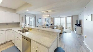 A modern kitchen with a central island, built-in appliances, and ample natural light. - Endless Summer Oasis (North Myrtle Beach)