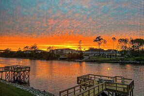 A waterfront property with a dock, a pier, and a row of houses along the water's edge. - Waterway Landing 216-A (North Myrtle Beach)