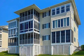 A multi-story building with a balcony on the second floor and a white picket fence surrounding the property. - Waterway Landing 216-A (North Myrtle Beach)