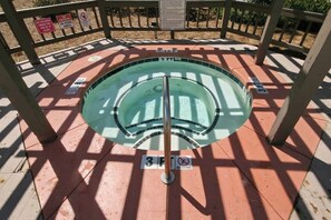 A circular pool with a central diving board, surrounded by a wooden deck with signs indicating no diving and no swimming in the pool area. - Tilghman Beach & Racquet 259 (North Myrtle Beach)