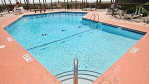 A rectangular swimming pool with lane dividers, surrounded by lounge chairs and a wooden deck. - Tilghman Beach & Racquet 214 (North Myrtle Beach)