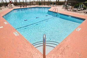 A rectangular swimming pool with lane dividers, surrounded by lounge chairs and a wooden deck. - Tilghman Beach & Racquet 214 (North Myrtle Beach)