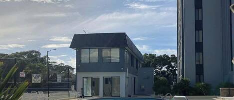 A swimming pool with a building in the background.