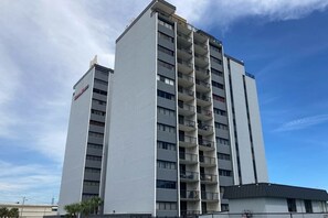 A multi-story building with balconies, likely a hotel or apartment complex. - Holiday Towers Unit 1001 (Myrtle Beach)