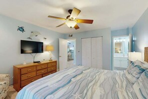 A bedroom with a bed, a ceiling fan, a TV, a dresser, and a walk-in closet. - Summertree Village D-4 (Myrtle Beach)