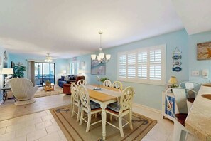 A spacious living room with a dining area, a ceiling fan, and a view to the outside. - Summertree Village D-4 (Myrtle Beach)