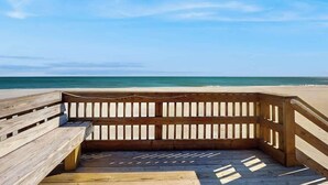 A wooden boardwalk leading to a beach with a clear sky. - Renaissance Tower 1114 (Myrtle Beach)