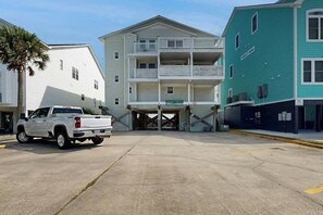 A white pickup truck parked in front of a building with a balcony and a sign that reads 'Chicory Manor.' - Breathtaking Beach Views (North Myrtle Beach)