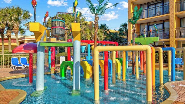 A water park with colorful play structures and a pool. - Caravelle Resort 206 (Myrtle Beach)