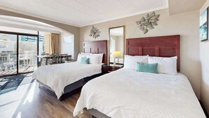 A hotel room with two beds, a balcony with a table and chairs, and a large window. - Caravelle Resort 206 (Myrtle Beach)