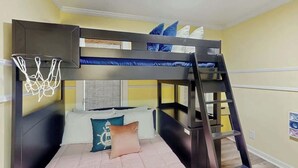 A bunk bed room with a basketball hoop, a ladder, and a window with blinds. - Lighthouse Retreat at the Beach (Myrtle Beach)
