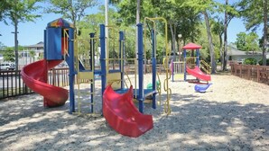 A playground with slides and climbing structures. - Renaissance Tower 317 (Myrtle Beach)