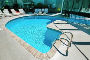 A swimming pool with a metal ladder and lounge chairs. - Renaissance Tower 317 (Myrtle Beach)