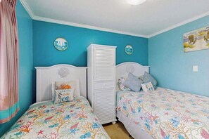 A bedroom with two beds, a wardrobe, and wall decorations. - Ocean Bridge 2-C5 Sunrise Shore (Myrtle Beach)