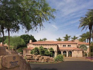 A desert-themed hotel with a terracotta roof, palm trees, and a rock formation labeled 'Sheraton Desert Oasis'. - 2 Bedroom Villa at Sheraton Desert Oasis Resort (Scottsdale)