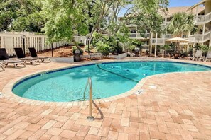 A swimming pool with lounge chairs and a brick deck. - Chelsea House Villas 112 (Myrtle Beach)