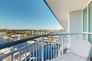 A balcony with a view of a marina and a bridge. - Harbourgate Unit 0620 (North Myrtle Beach)