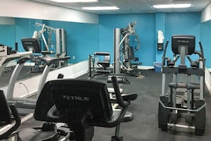 A gym with various exercise equipment, including treadmills and weight machines. - Sea Watch Unit 303 Condo (Myrtle Beach)