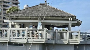 A beachfront building with a balcony, a covered area, and a view of the ocean. - Ocean Creek Lodge IV - 2287 (Myrtle Beach)