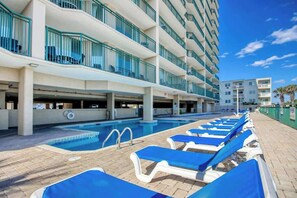 A hotel pool area with lounge chairs and a clear blue sky. - Windy Hill Dunes 204 (North Myrtle Beach)