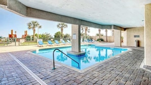 An indoor swimming pool with lounge chairs and a covered area. - Windy Hill Dunes 204 (North Myrtle Beach)