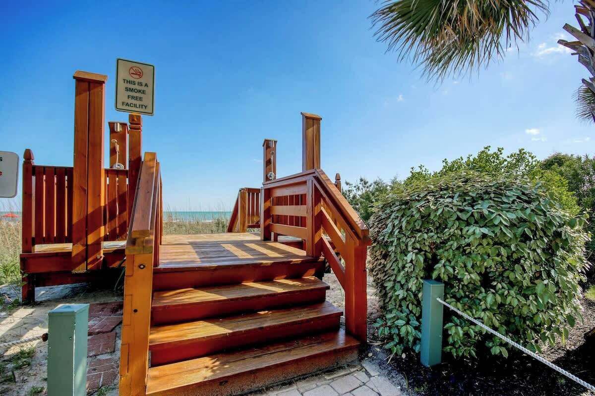 A wooden staircase leading to a smoke-free facility.