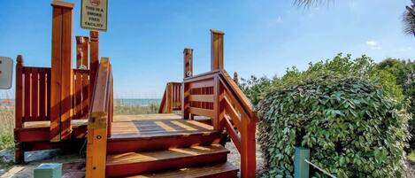 A wooden staircase leading to a smoke-free facility.