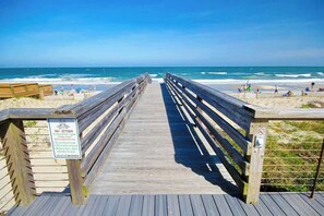A wooden boardwalk leading to a beach with a sign indicating no beachside lighting from May to October. - Marsh Hawk 3D at Litchfield by the Sea (Pawleys Island)