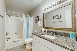 A bathroom with a bathtub, toilet, and sink. - Beach Life Retreat Home (Myrtle Beach)
