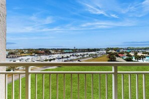 A marina with boats, a clear sky, and a distant view of a town. - Yacht Club Villas 1-501 (North Myrtle Beach)