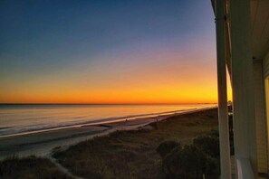 A coastal view from a window overlooking a beach with a clear sky. - Ocean Pier 3 Unit - 322 (North Myrtle Beach)