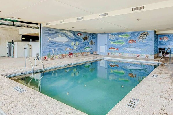 An indoor swimming pool with a mural of marine life on the walls. - Ashworth Unit 1305 Condo (North Myrtle Beach)