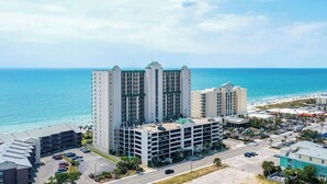 A high-rise hotel with multiple floors, a parking garage, and a view of the ocean. - Ashworth Unit 1305 Condo (North Myrtle Beach)