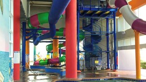An indoor water park with multiple slides and a pool area. - Beachfront Bliss Retreat (Myrtle Beach)