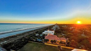 A coastal property with a long beachfront, a row of houses, and a clear sky. - Beachfront Bliss Retreat (Myrtle Beach)