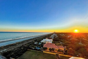 A coastal property with a long beachfront, a row of houses, and a clear sky. - Beachfront Bliss Retreat (Myrtle Beach)