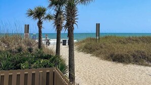 A sandy beach path with palm trees and a wooden fence. - A Place at the Beach VI - 105 (Myrtle Beach)
