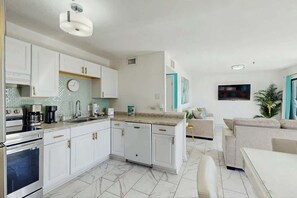 A modern kitchen with white cabinets, a built-in oven, and a coffee maker. - Myrtle Beach Resort 344B (Myrtle Beach)