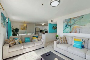 A modern living room with two sofas, a coffee table, and a kitchen in the background. - Myrtle Beach Resort 344B (Myrtle Beach)