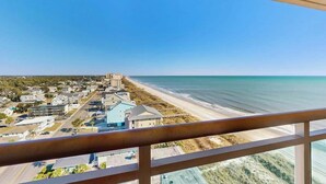 A coastal town with a beach, buildings, and a clear sky. - Bahama Sands Unit PH02 (North Myrtle Beach)