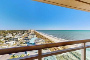 A coastal town with a beach, buildings, and a clear sky. - Bahama Sands Unit PH02 (North Myrtle Beach)