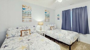 A bedroom with two beds, a ceiling fan, and a window with curtains. - Serenity Now Retreat (Murrells Inlet)
