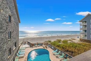 A pool area with a view of the beach and ocean. - Serenity Now Retreat (Murrells Inlet)