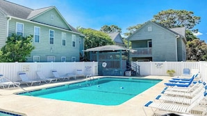 A pool area with lounge chairs, a lifeguard station, and a fenced deck. - Willow Winds Unit 17 (North Myrtle Beach)
