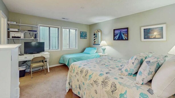 A bedroom with a bed, a desk with a computer, a television, and a window with blinds. - Willow Winds Unit 17 (North Myrtle Beach)