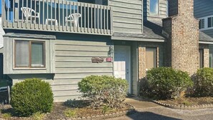 A two-story building with a balcony, a mailbox, and a small garden area. - Willow Winds Unit 17 (North Myrtle Beach)